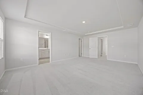 a view of an empty room with closet area