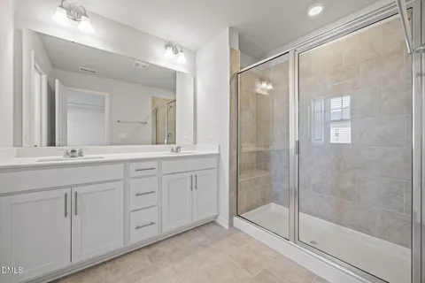 a bathroom with a shower sink and mirror
