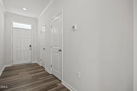 a view of a hallway with wooden floor