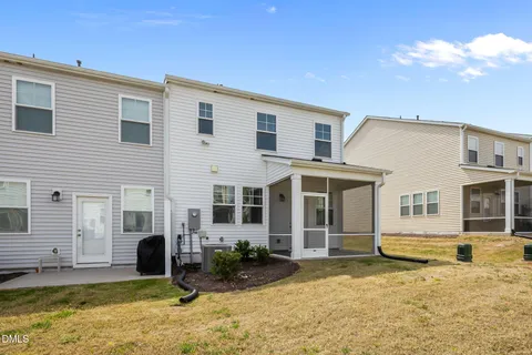 a view of a white house with swimming pool in front of it