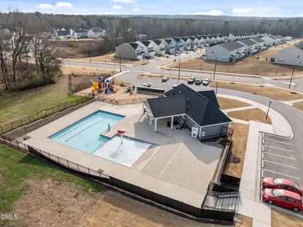 an aerial view of a house with swimming pool and mountain view