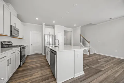 a kitchen with stainless steel appliances sink refrigerator and stove