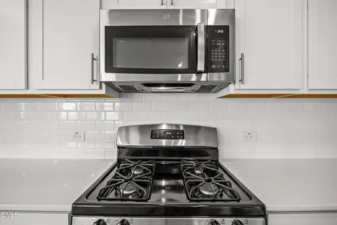 a stove top oven sitting inside of a kitchen