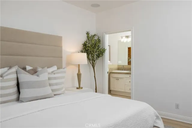 a bedroom with a bed and a potted plant