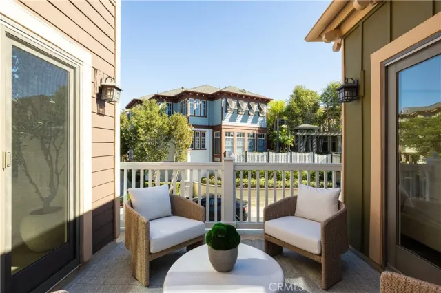 a balcony with furniture and a potted plant