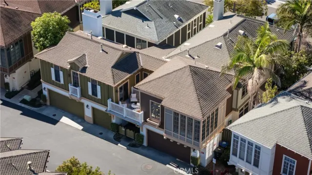 an aerial view of residential houses with car parked