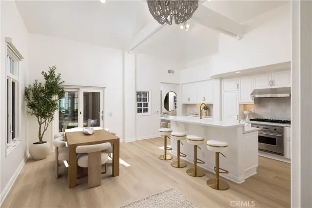a living room with furniture a dining table and kitchen view
