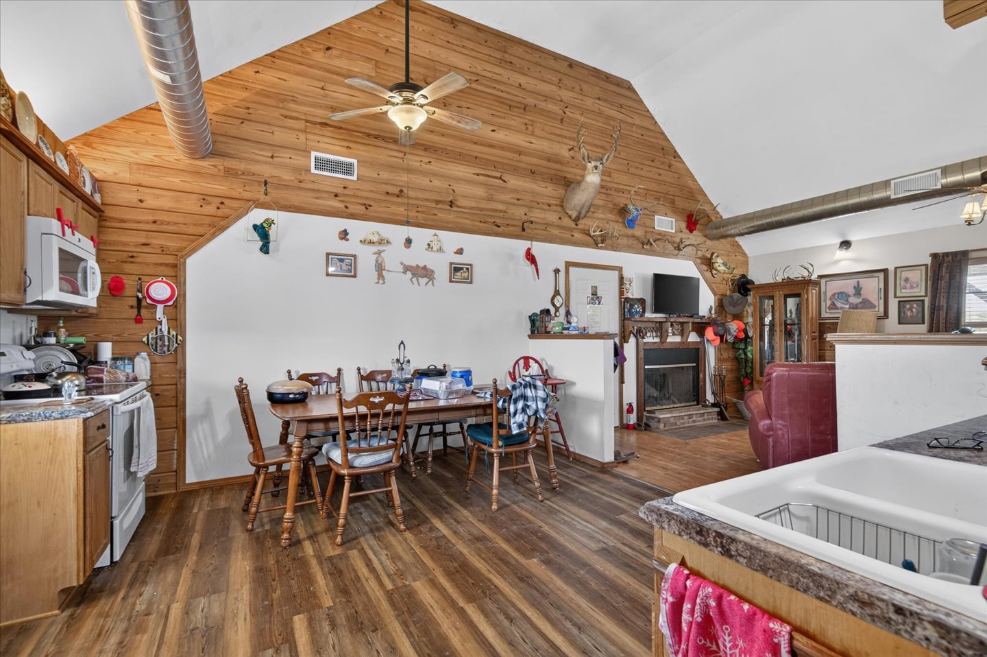 26115 4157th Road Nowata, OK 74048 - Photo 14 of 36 Open-concept living space featuring cathedral wood-beam ceilings, warm wood-finish flooring throughout, and abundant natural light
