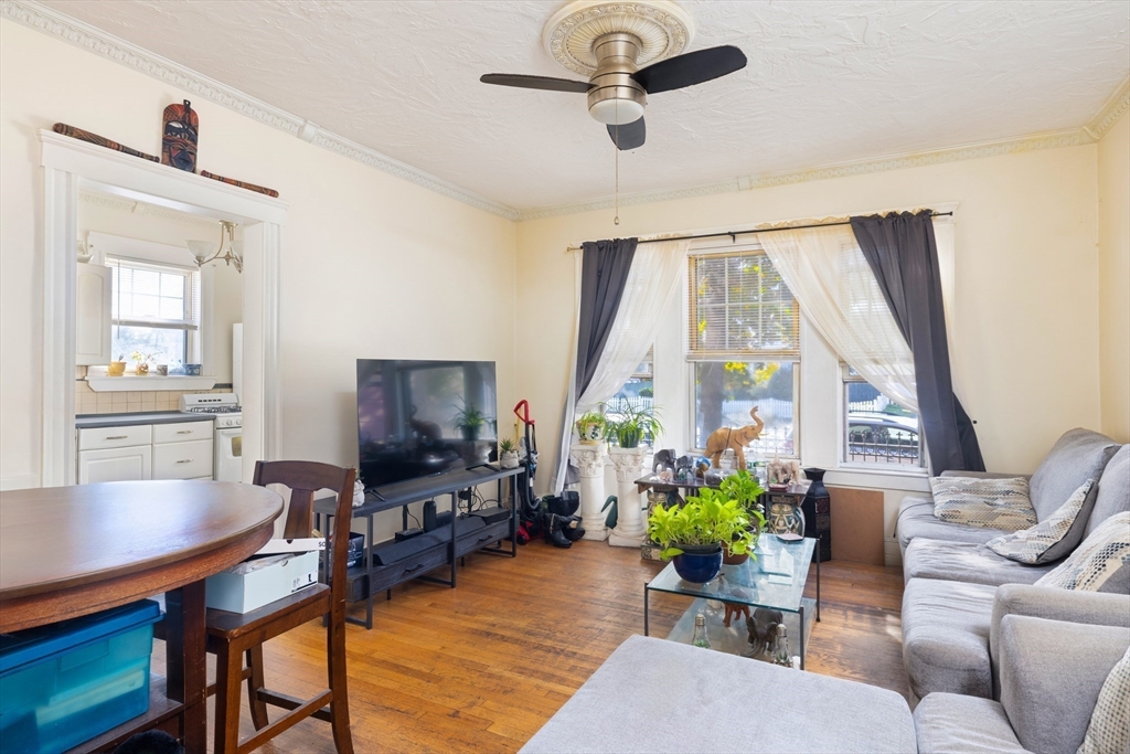 99 Franklin Street Lynn, MA 01902 - Photo 4 of 11 a living room with furniture a flat screen tv and a large window