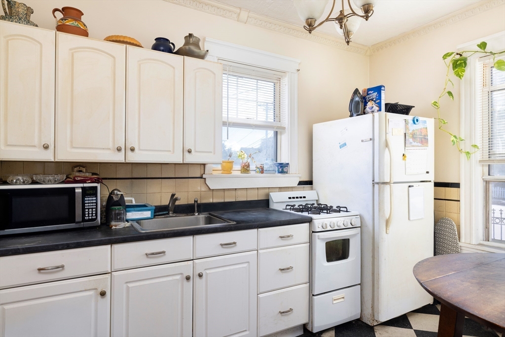 99 Franklin Street Lynn, MA 01902 - Photo 5 of 11 a kitchen with appliances a sink and cabinets