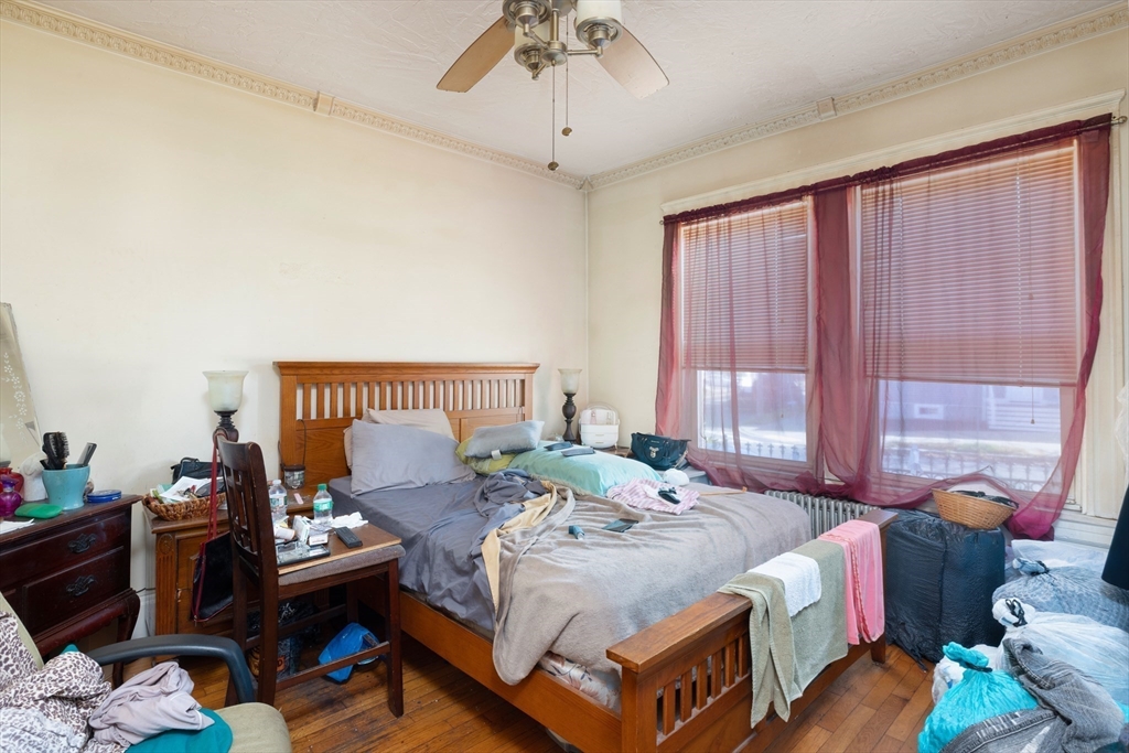 99 Franklin Street Lynn, MA 01902 - Photo 7 of 11 a bed room with a bed and a chandelier
