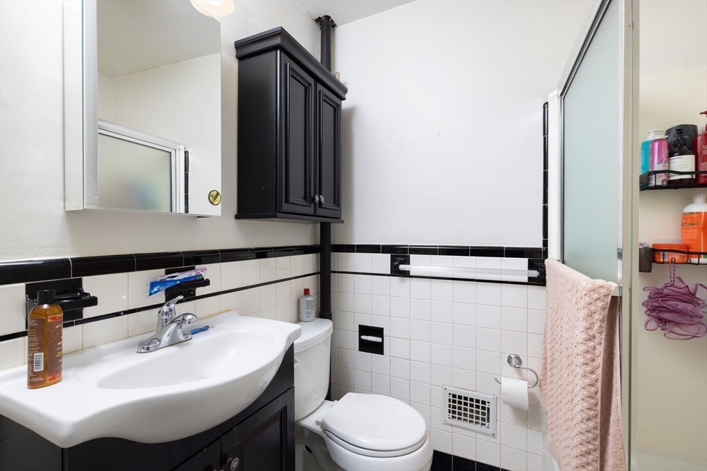 99 Franklin Street Lynn, MA 01902 - Photo 10 of 11 a bathroom with a sink toilet and mirror