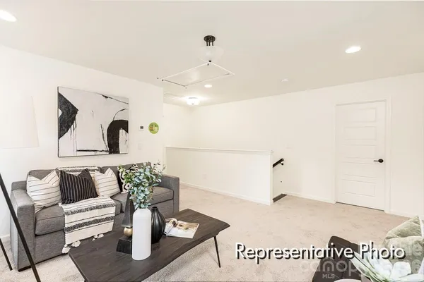 a living room with furniture and white walls