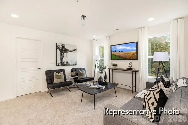 a view of a livingroom with furniture and a flat screen tv