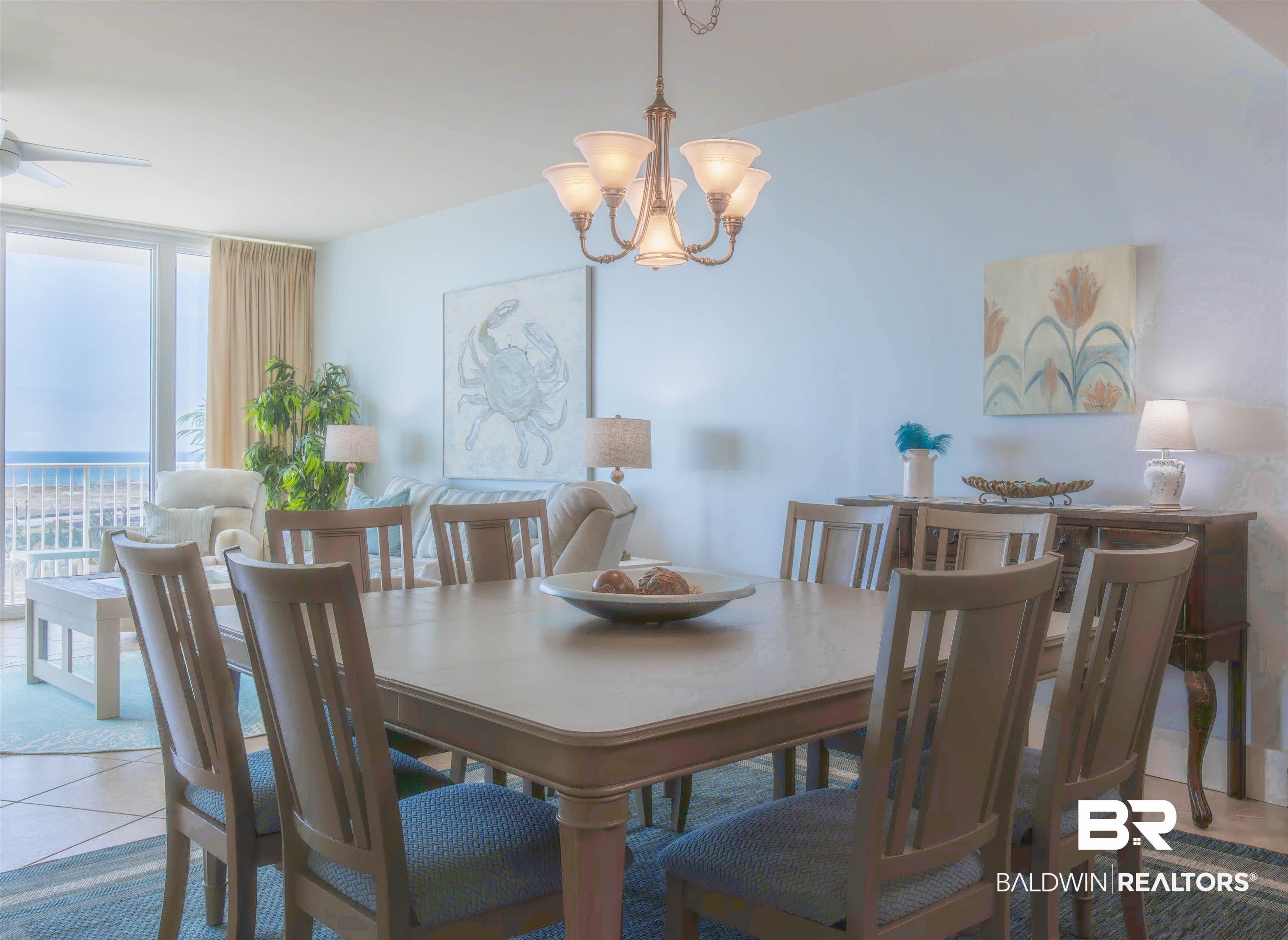 28107 Perdido Beach Boulevard, Unit D714 Orange Beach, AL 36561 - Photo 15 of 88 Tiled dining room with a wall of windows and ceiling fan with notable chandelier