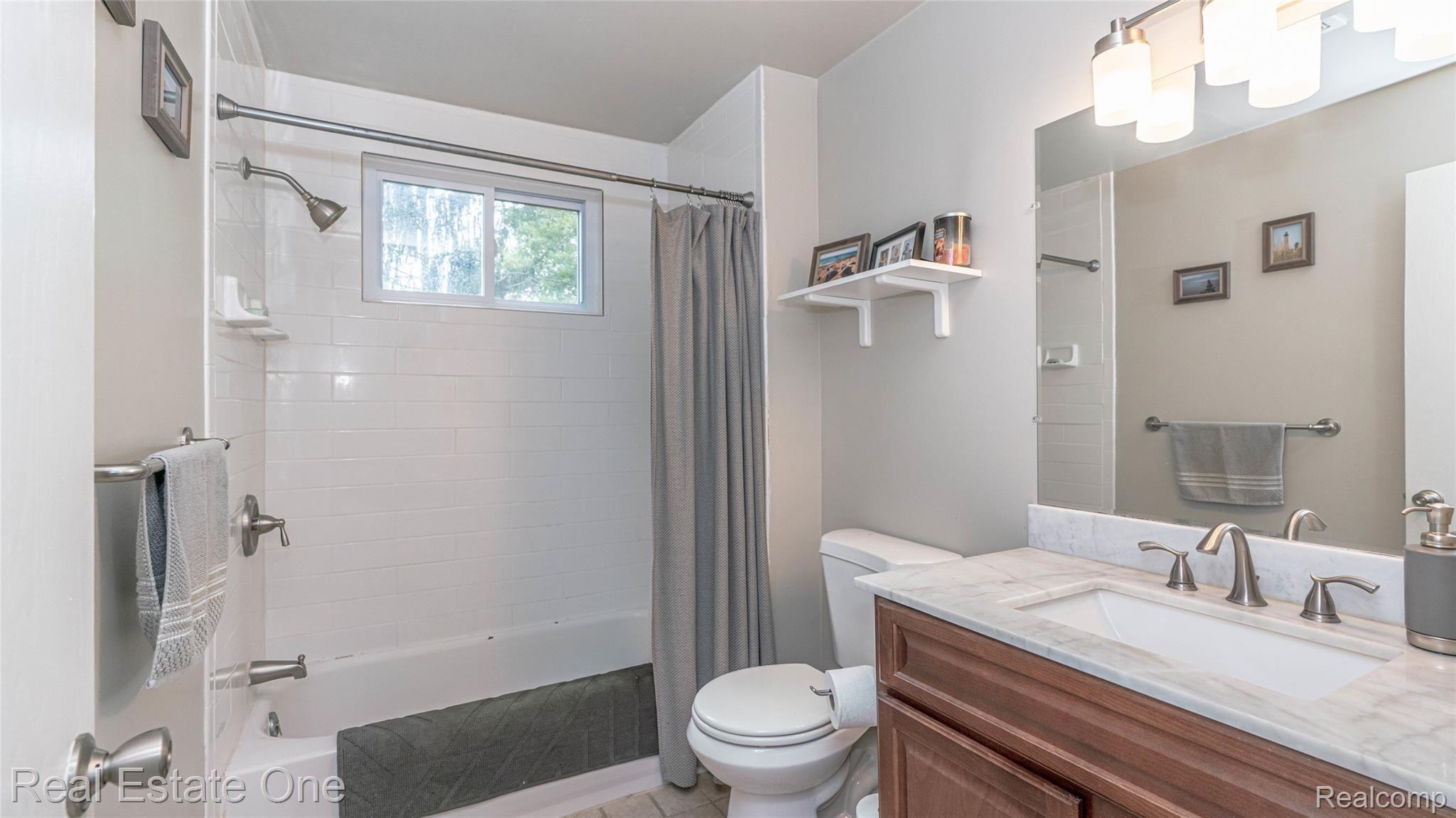 5997 Coppersmith Road Waterford, MI 48327 - Photo 25 of 45 Full bath. Upper level with subway tile in shower and window, new vanity, satin nickel fixtures
