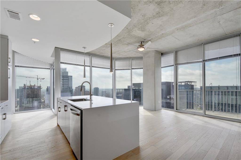 a dining hall with stainless steel appliances granite countertop a sink and a refrigerator