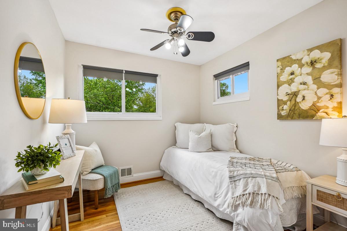 827 Caddington Avenue Silver Spring, MD 20901 - Photo 26 of 45 a bedroom with a bed wooden floor and a large window