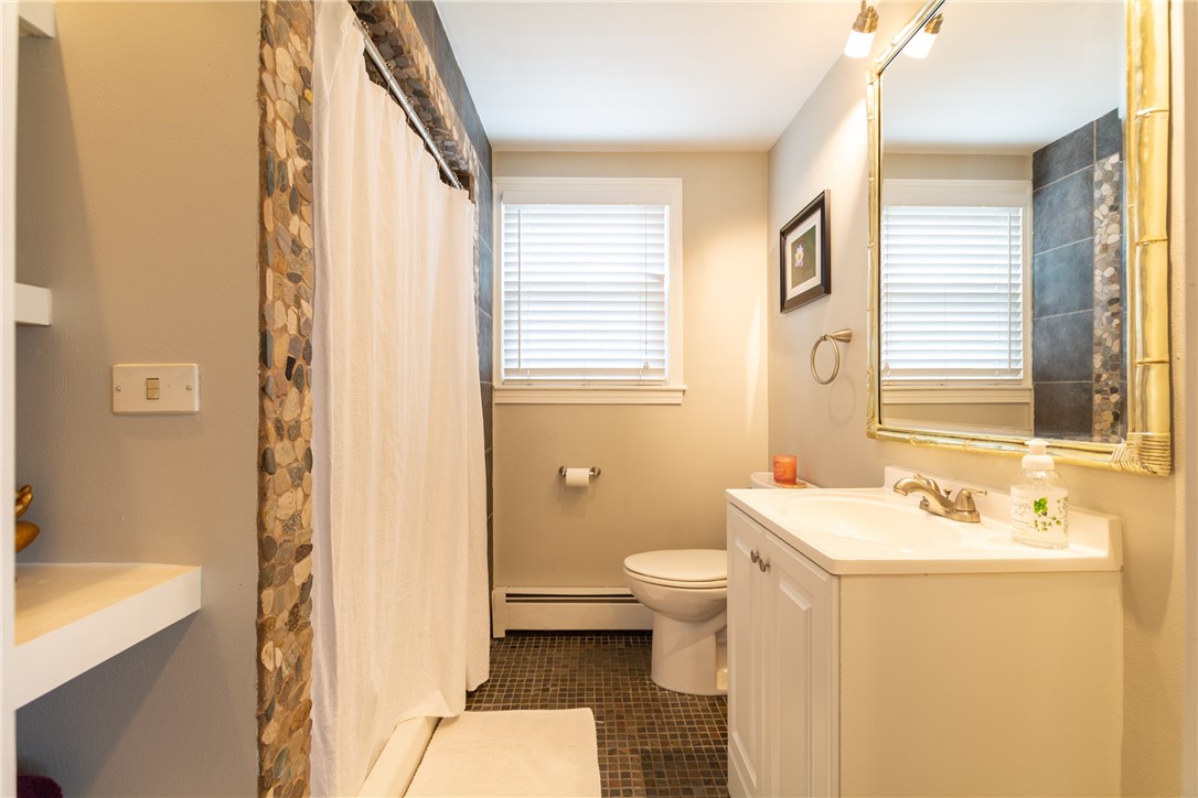 8 Curtis Road Bristol, RI 02809 - Photo 31 of 50 First floor bathroom with full shower and updated vanity.