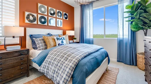 a bedroom with a bed and a potted plant