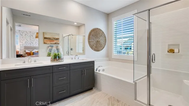a bathroom with a tub sink and mirror