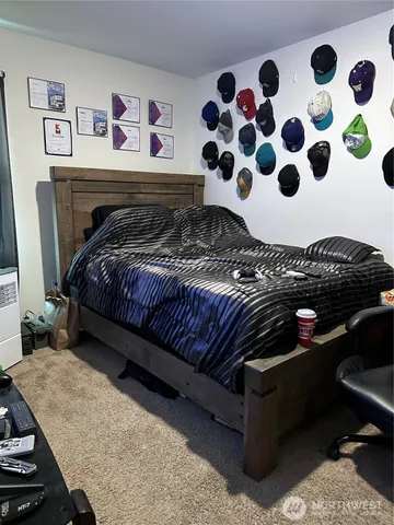 a bedroom with a bed and a painting on the wall