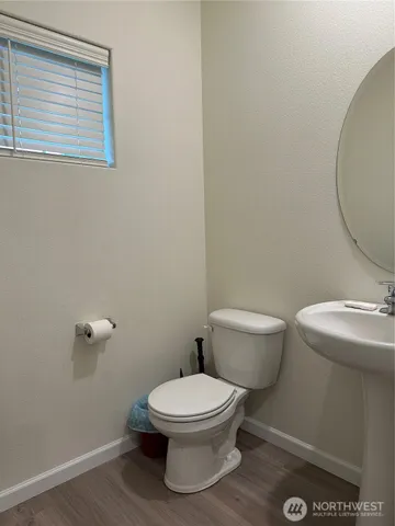 a white toilet sitting next to a bathroom sink