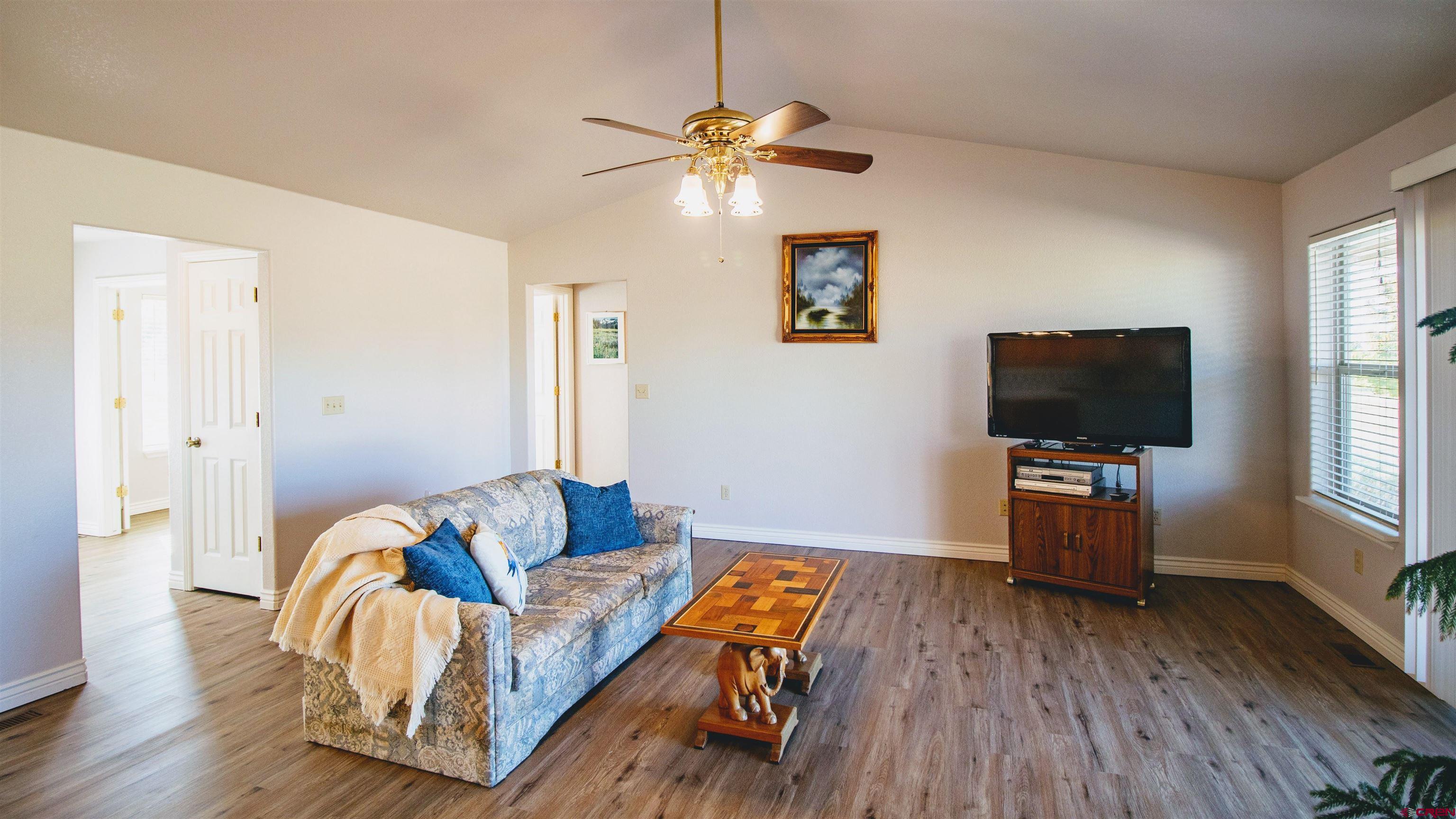 18641 2375th Road Cedaredge, CO 81413 - Photo 11 of 35 a living room with furniture and a flat screen tv