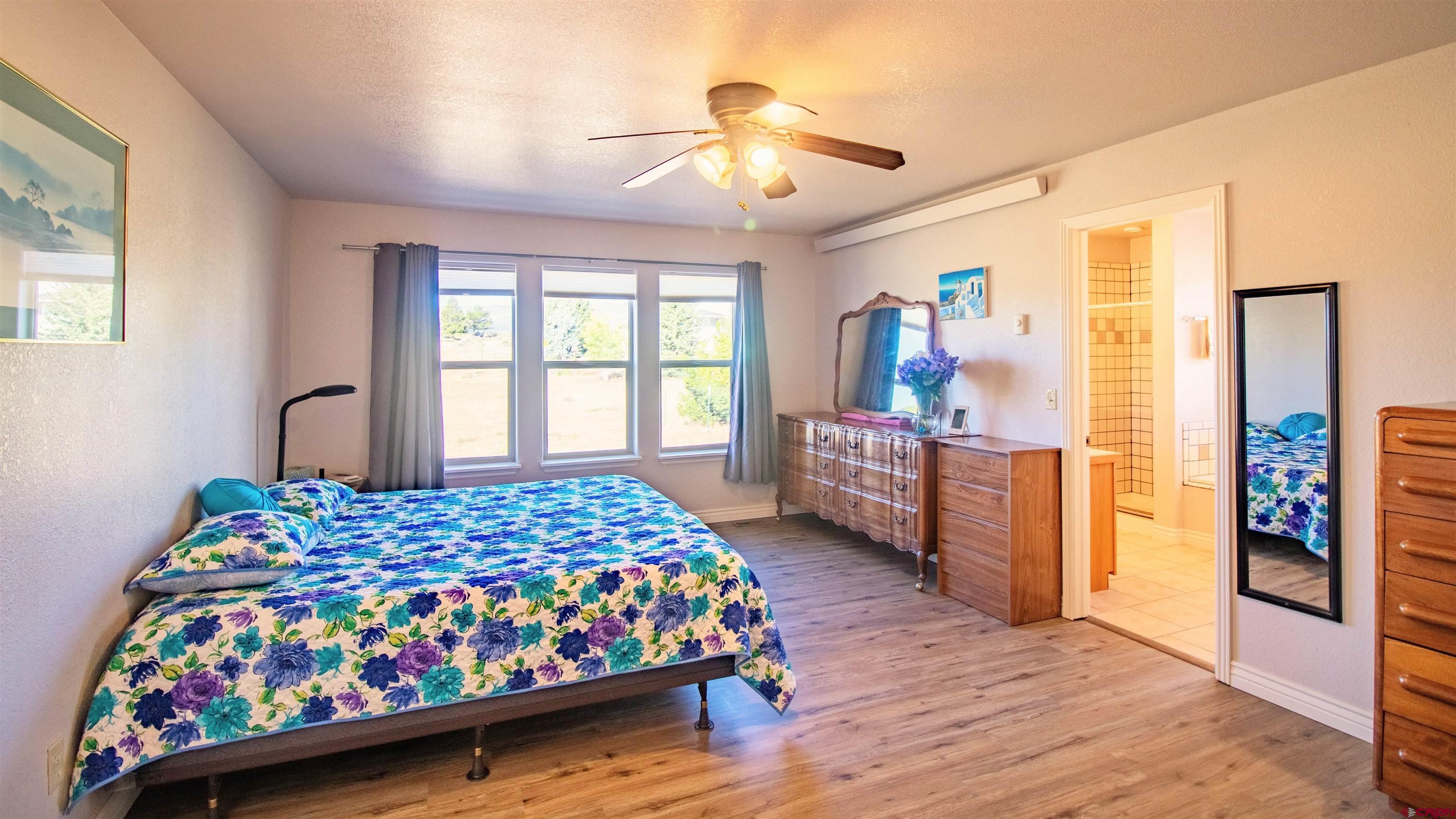18641 2375th Road Cedaredge, CO 81413 - Photo 16 of 35 a bedroom with a bed and wooden floor