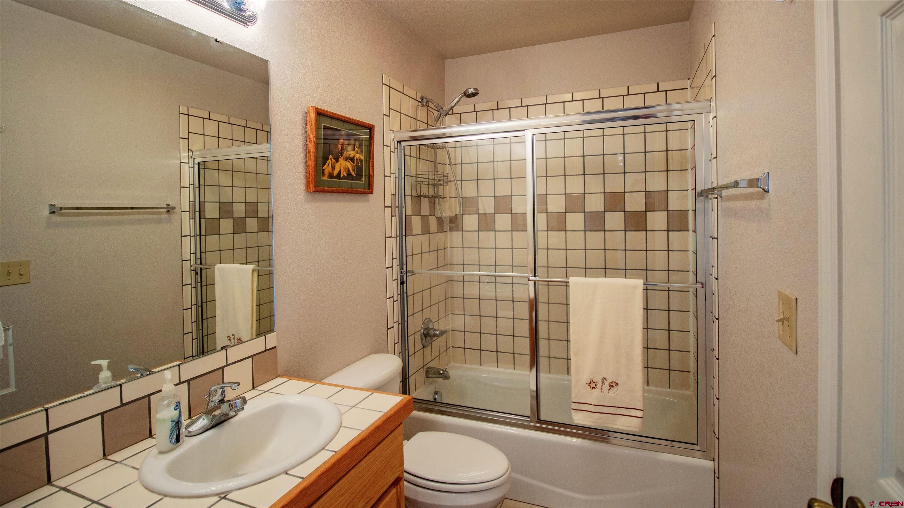 18641 2375th Road Cedaredge, CO 81413 - Photo 21 of 35 a bathroom with a sink toilet and shower