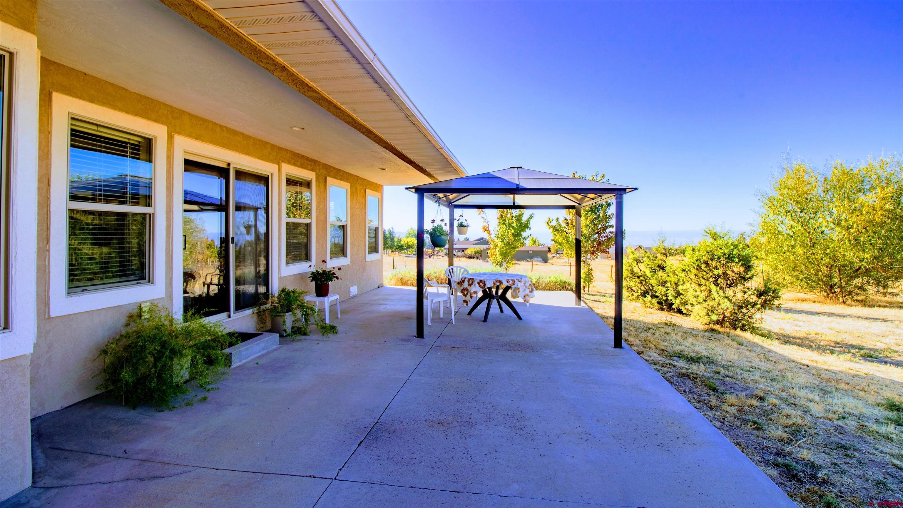 18641 2375th Road Cedaredge, CO 81413 - Photo 24 of 35 a view of a patio with table and chairs and potted plants