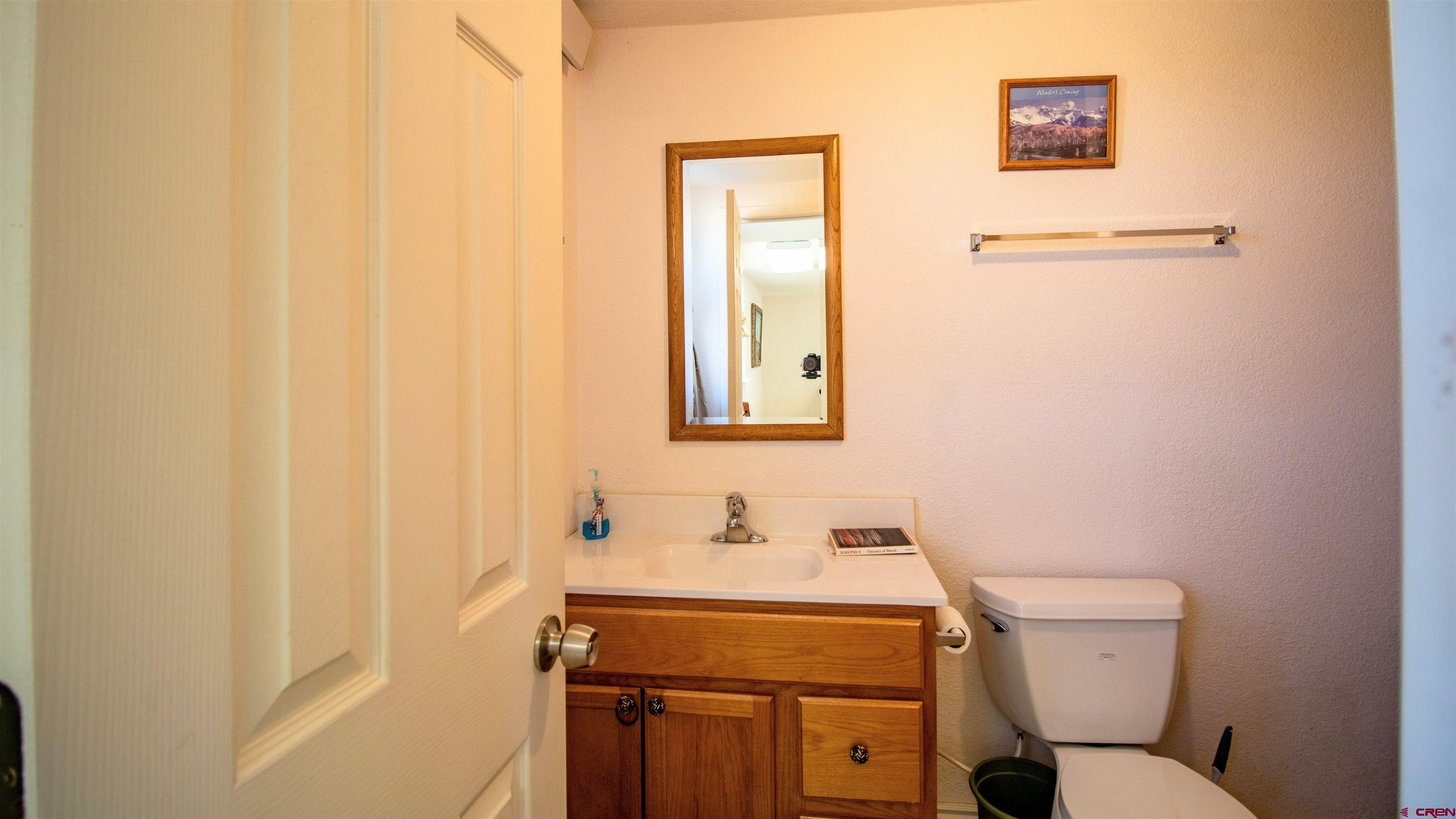 18641 2375th Road Cedaredge, CO 81413 - Photo 29 of 35 a bathroom with a sink toilet and a mirror