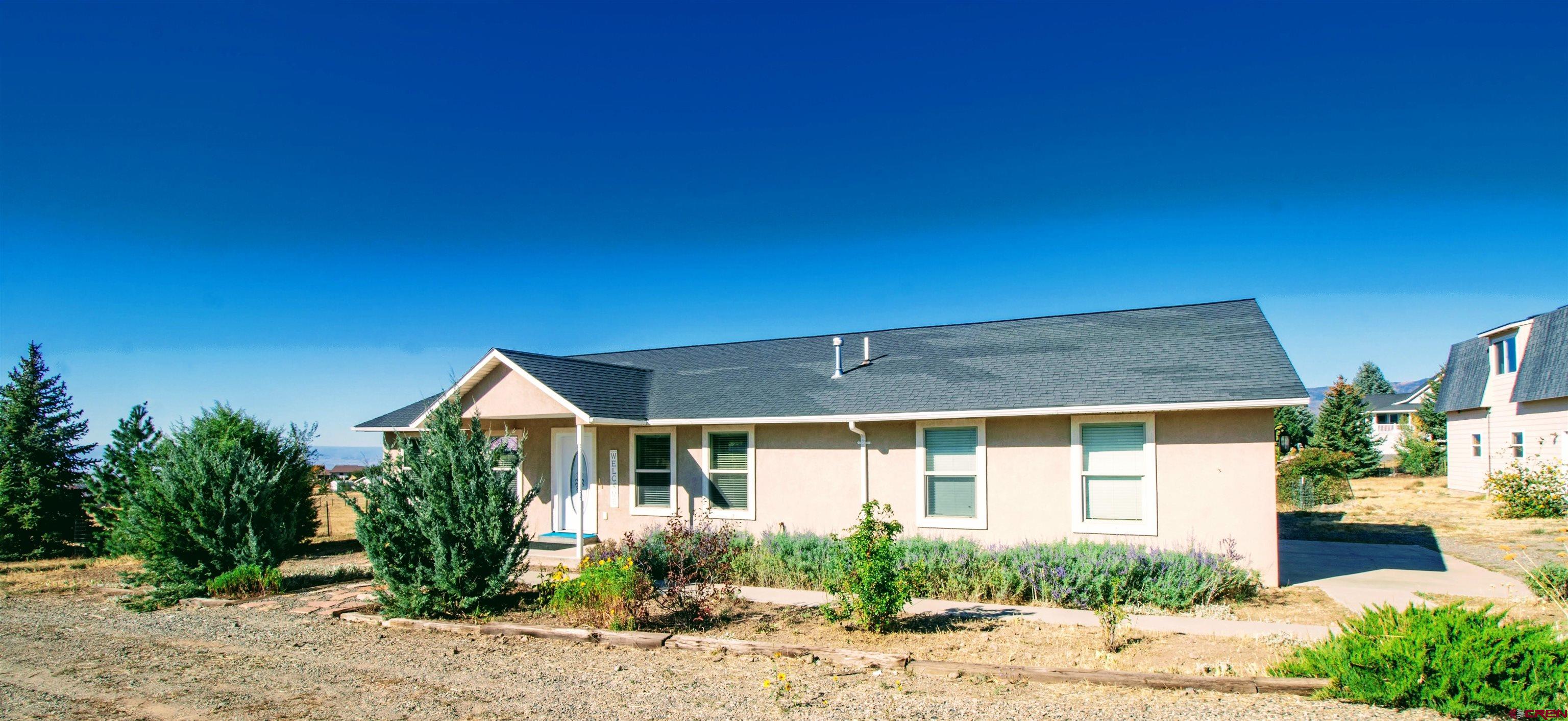 18641 2375th Road Cedaredge, CO 81413 - Photo 5 of 35 a front view of a house with garden