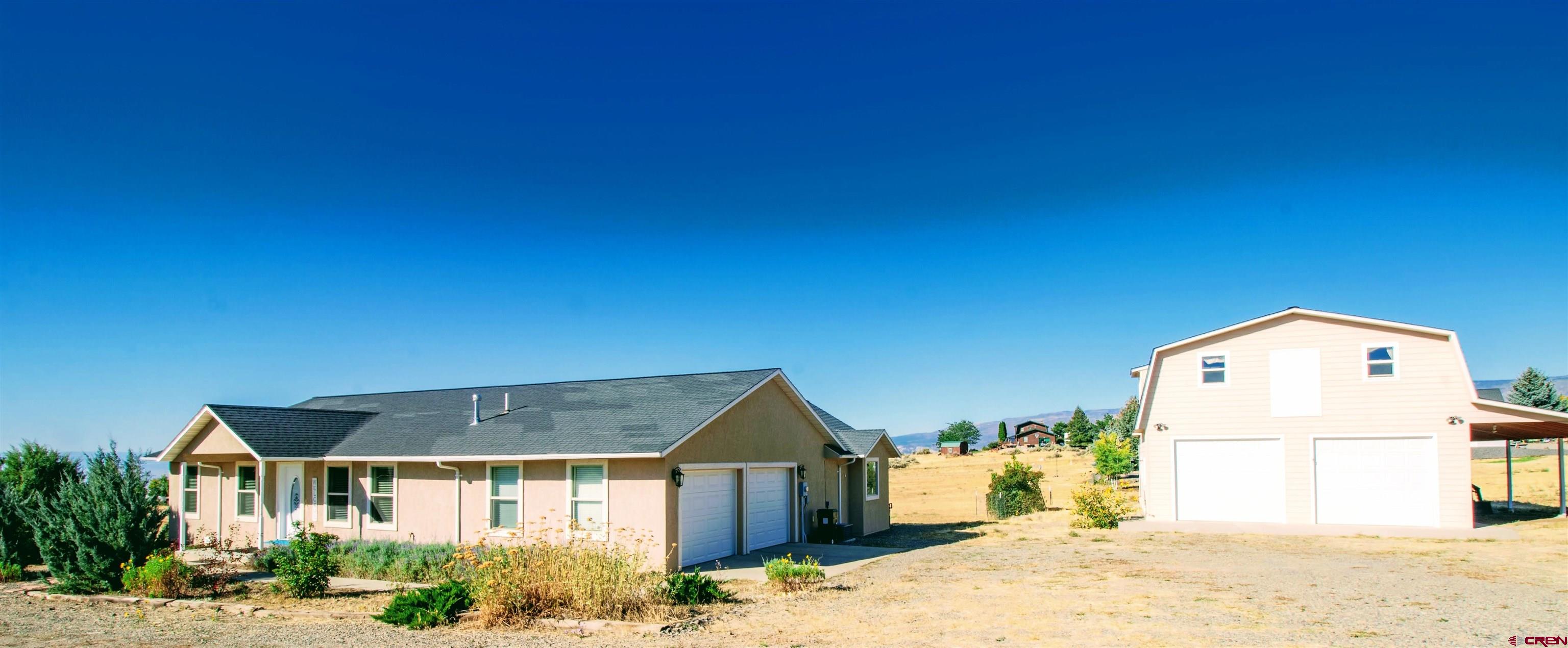 18641 2375th Road Cedaredge, CO 81413 - Photo 6 of 35 a front view of a house with a yard