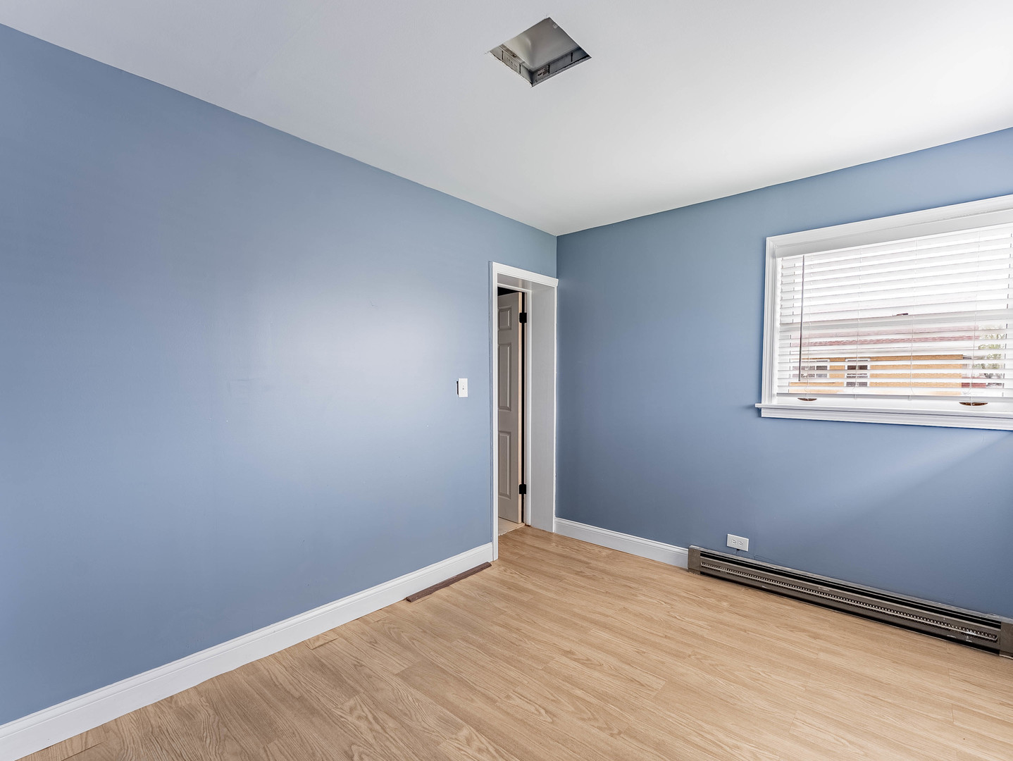 2246 Clinton Avenue Berwyn, IL 60402 - Photo 11 of 23 an empty room with wooden floor and windows