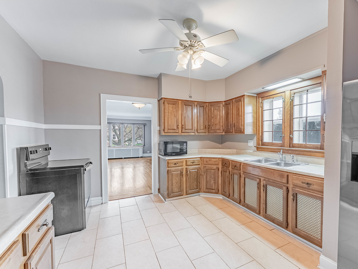 2246 Clinton Avenue Berwyn, IL 60402 - Photo 13 of 23 a large kitchen with cabinets and wooden floor