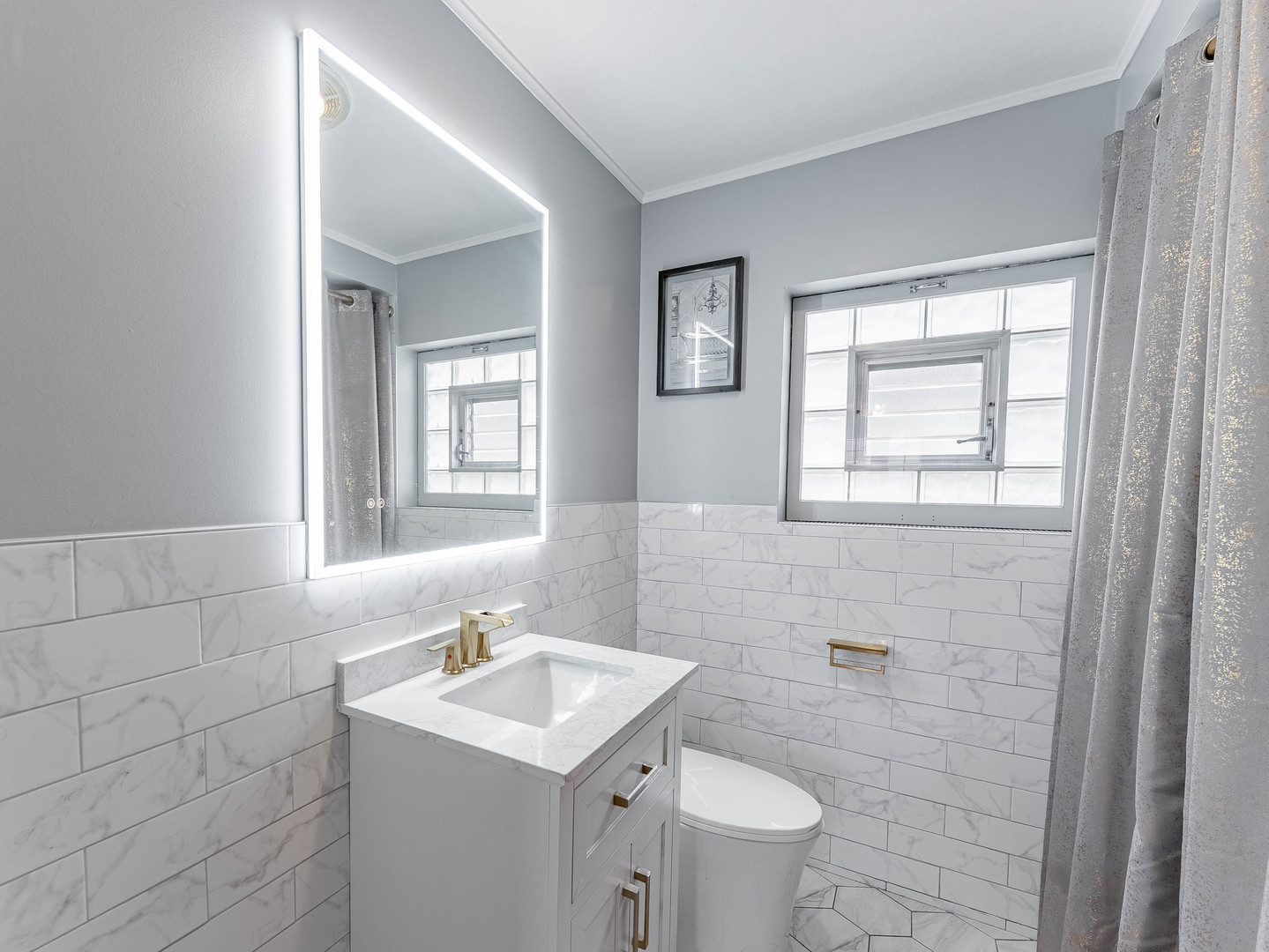 2246 Clinton Avenue Berwyn, IL 60402 - Photo 14 of 23 a bathroom with a sink a toilet and a mirror