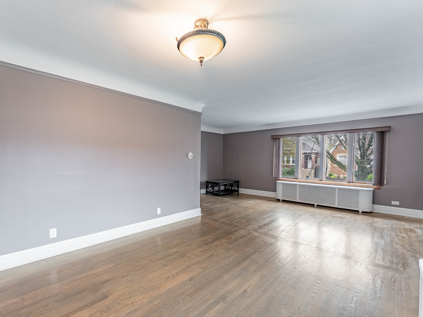 2246 Clinton Avenue Berwyn, IL 60402 - Photo 4 of 23 an empty room with wooden floor and windows