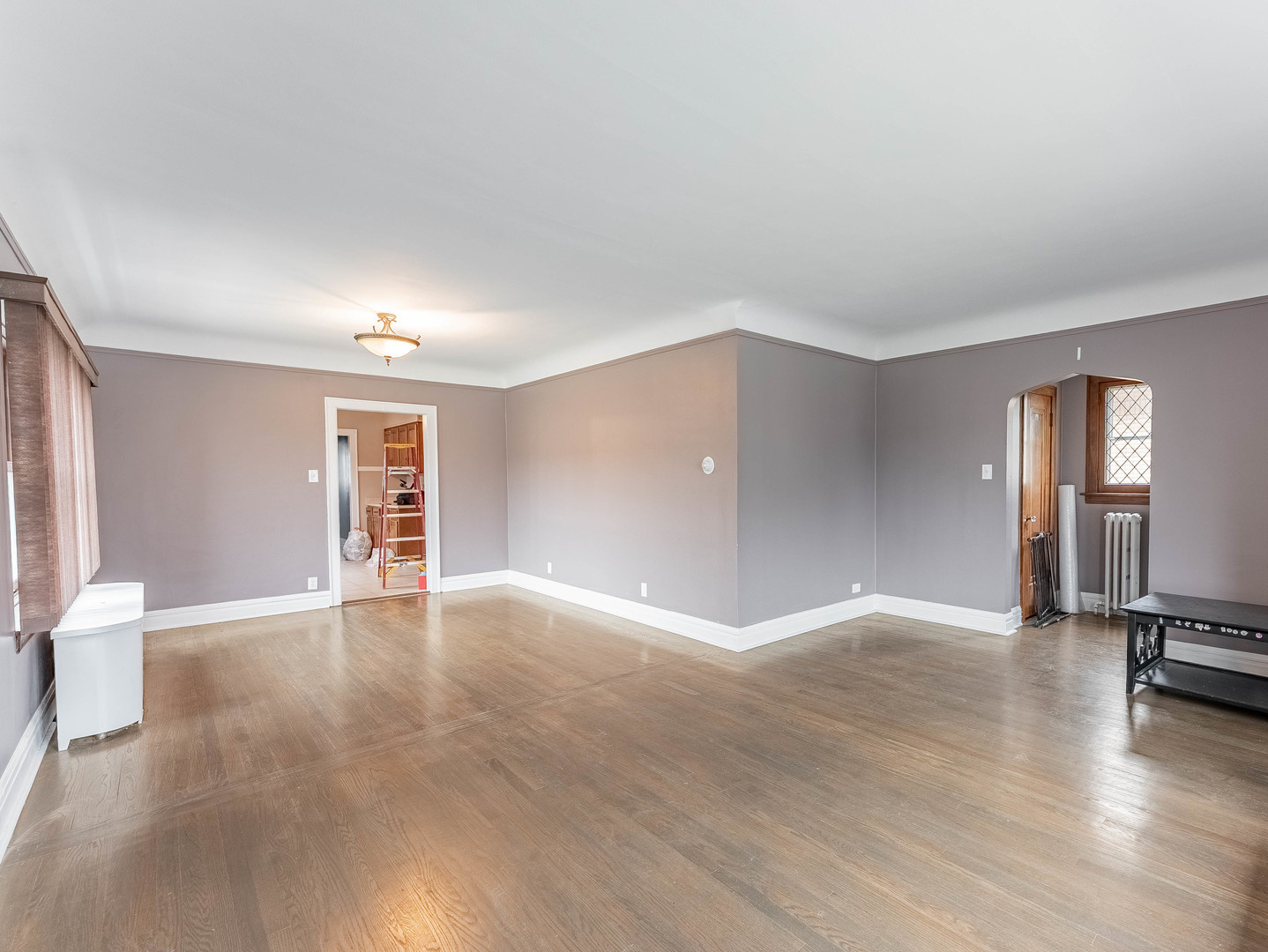 2246 Clinton Avenue Berwyn, IL 60402 - Photo 5 of 23 a view of an empty room with window and wooden floor