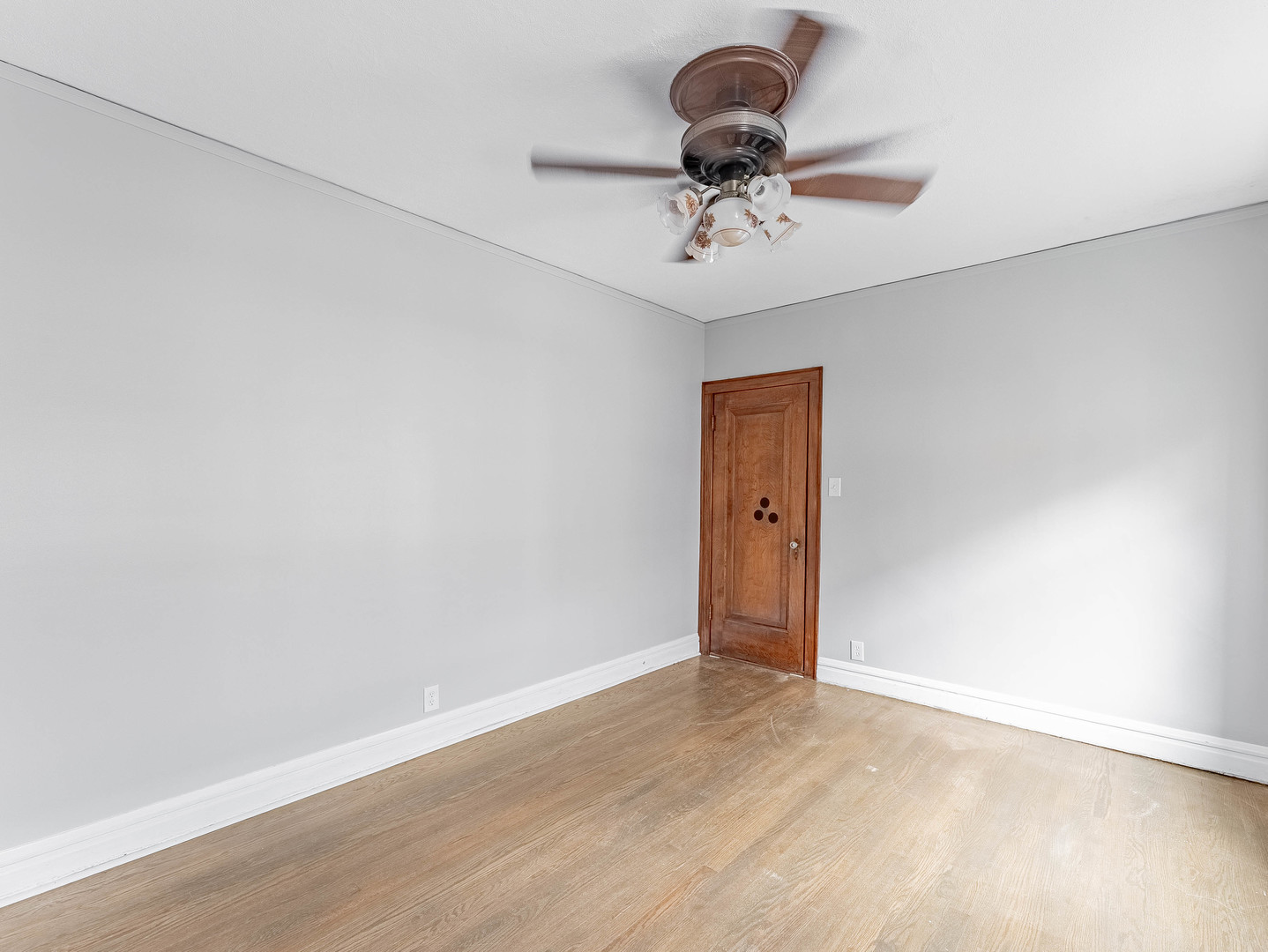 2246 Clinton Avenue Berwyn, IL 60402 - Photo 9 of 23 a view of a room with a wooden floor and a ceiling fan