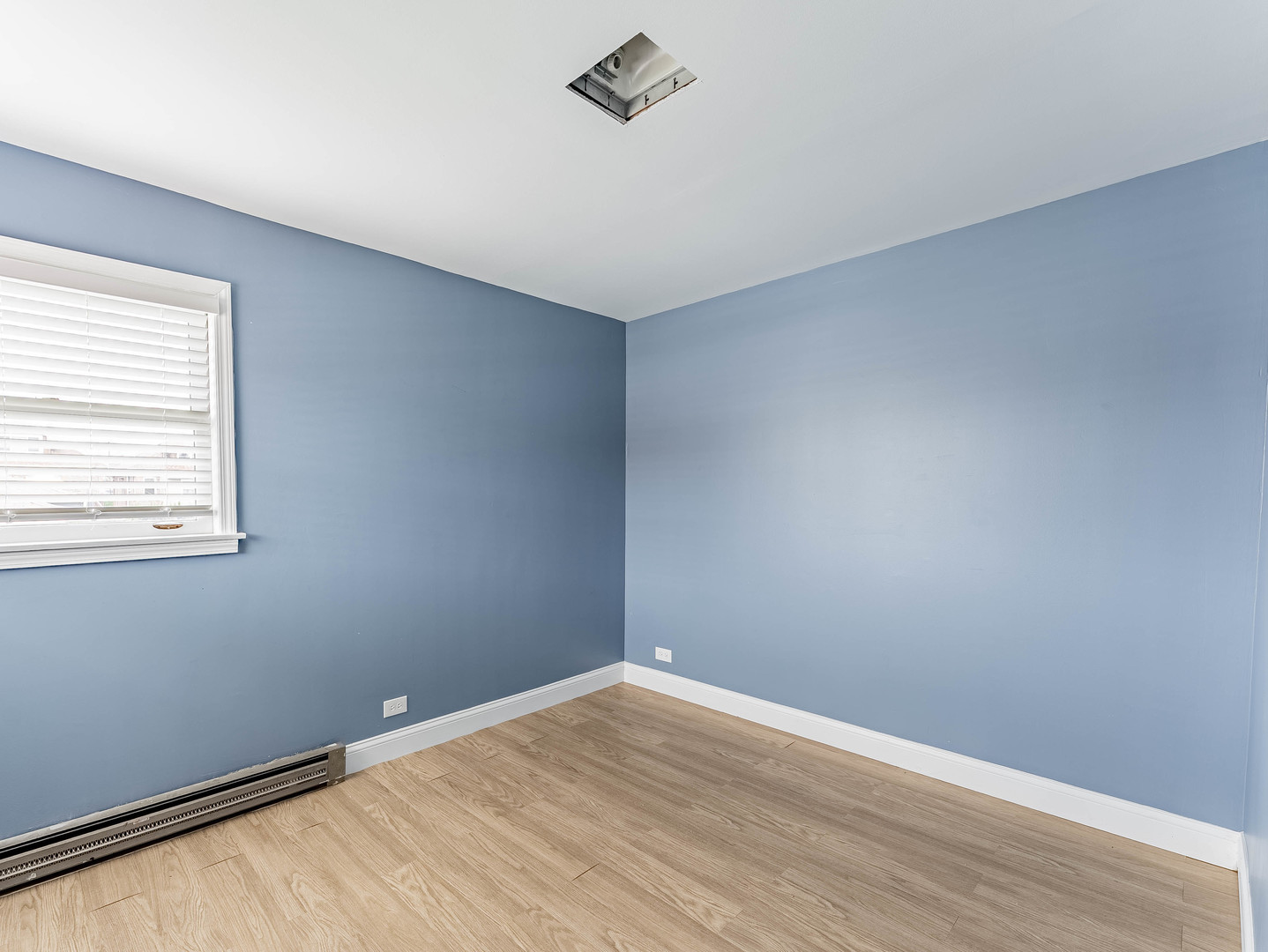 2246 Clinton Avenue Berwyn, IL 60402 - Photo 10 of 23 a view of an empty room with wooden floor and a window