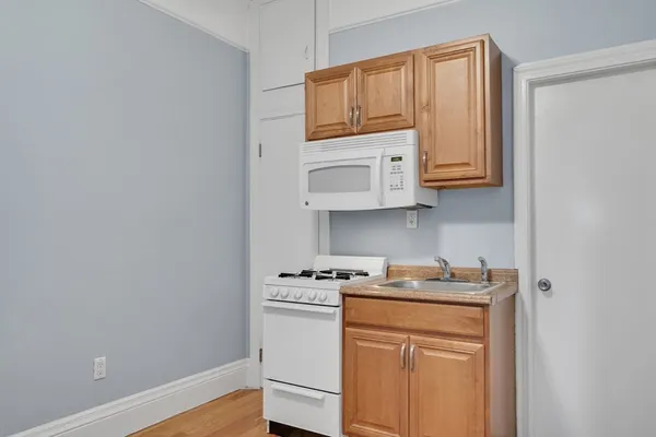 a kitchen with stainless steel appliances granite countertop a stove a microwave and cabinets