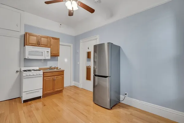 a kitchen with stainless steel appliances a refrigerator and a stove top oven