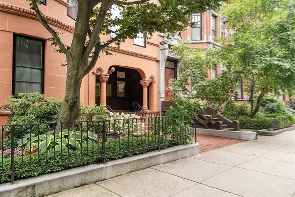 a couple of potted plants in front of a building