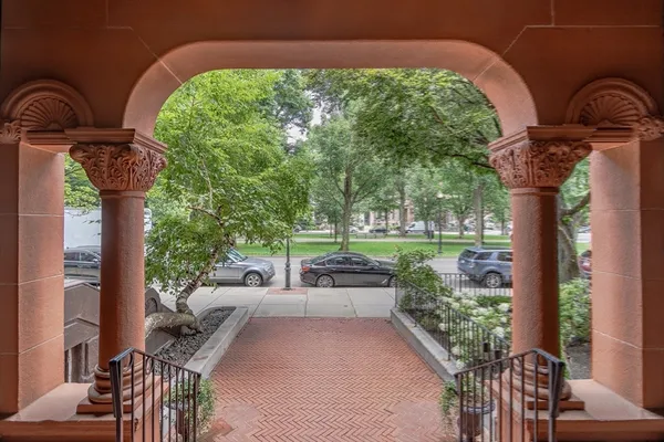 a view of a park with bench and trees