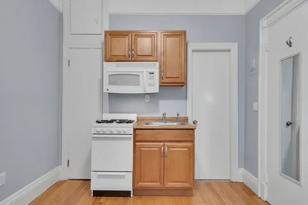 a kitchen with stainless steel appliances granite countertop a stove and a microwave