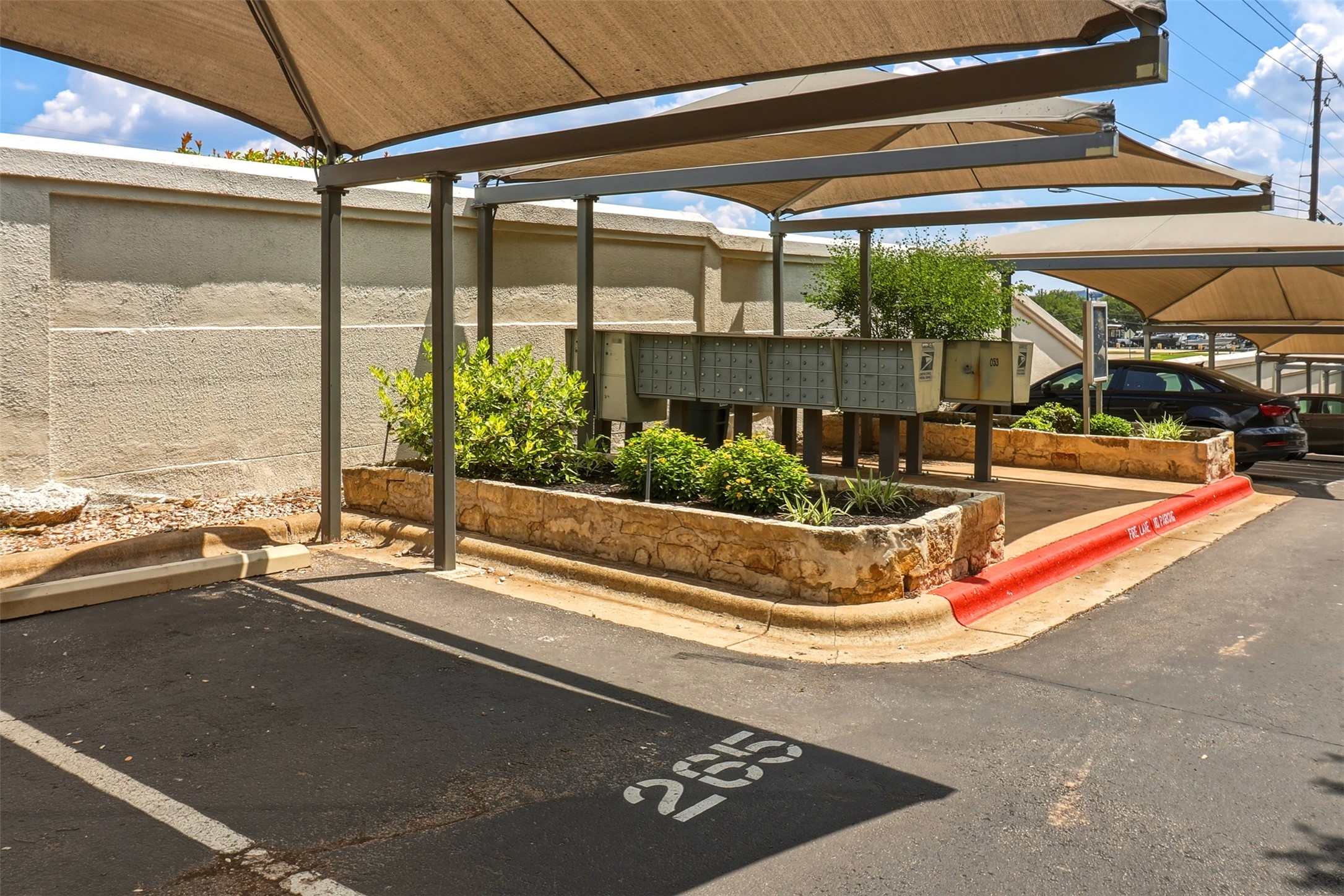 2918 Ranch Road 620, Unit 265 Austin, TX 78734 - Photo 38 of 40 Covered parking spaces offer protection for vehicles and convenient access to mailboxes.