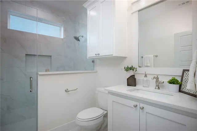 a bathroom with a sink a toilet and vanity