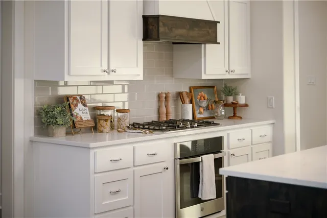 a kitchen with white cabinets and white appliances