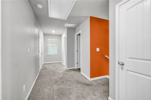 a view of a hallway with wooden shelves